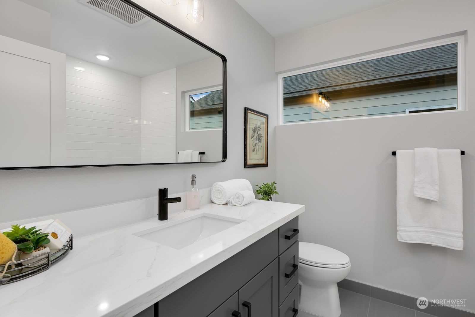 1006 B South Donovan Street Seattle, WA 98108 - Photo 12 of 14 a bathroom with a sink a toilet and mirror
