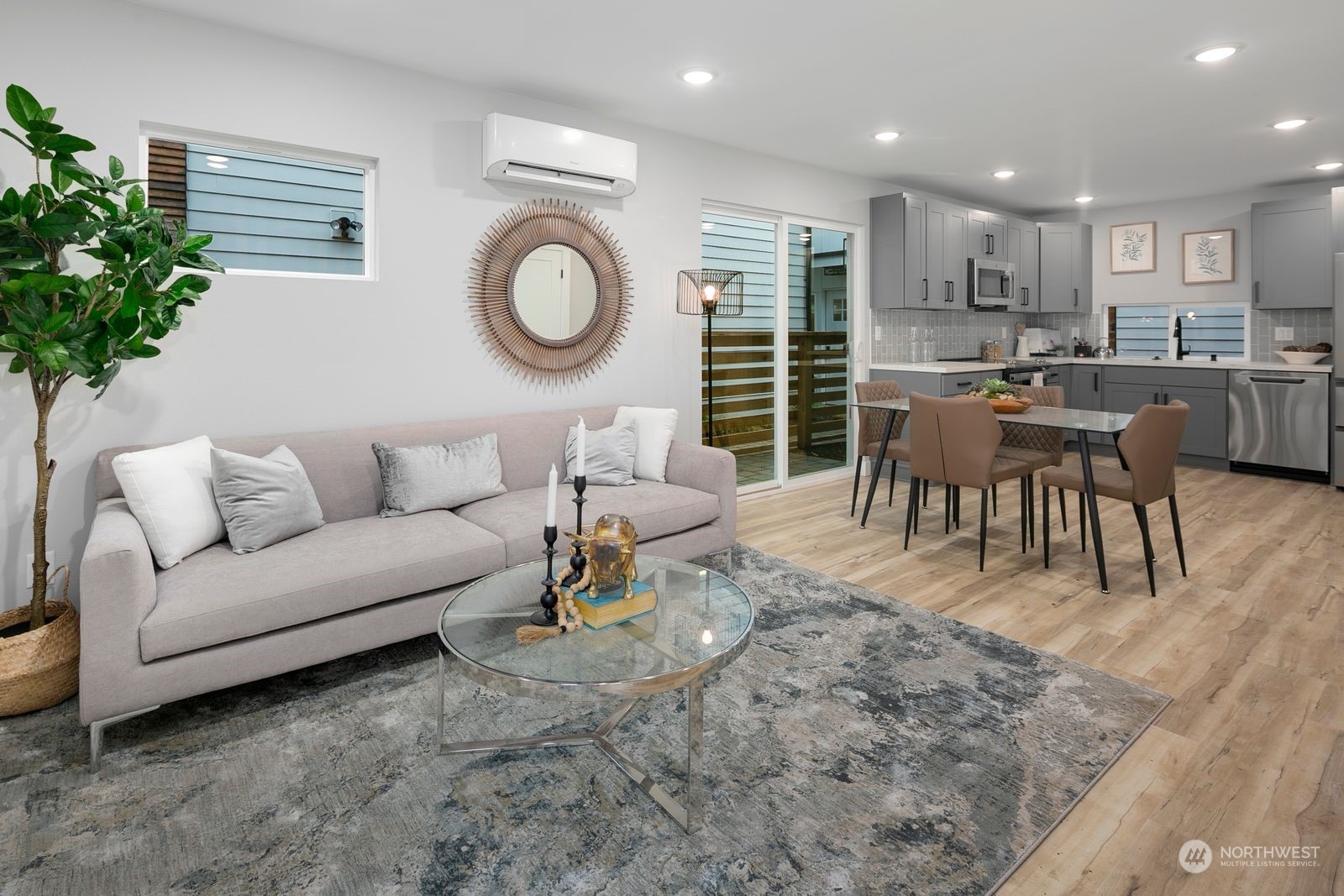 1006 B South Donovan Street Seattle, WA 98108 - Photo 3 of 14 a living room with furniture a clock and a view of kitchen