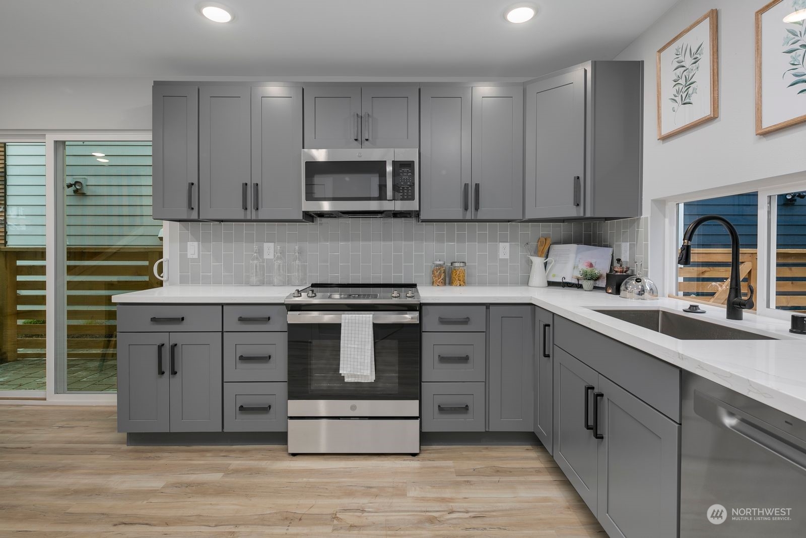 1006 B South Donovan Street Seattle, WA 98108 - Photo 8 of 14 a kitchen with stainless steel appliances granite countertop a stove sink and cabinets
