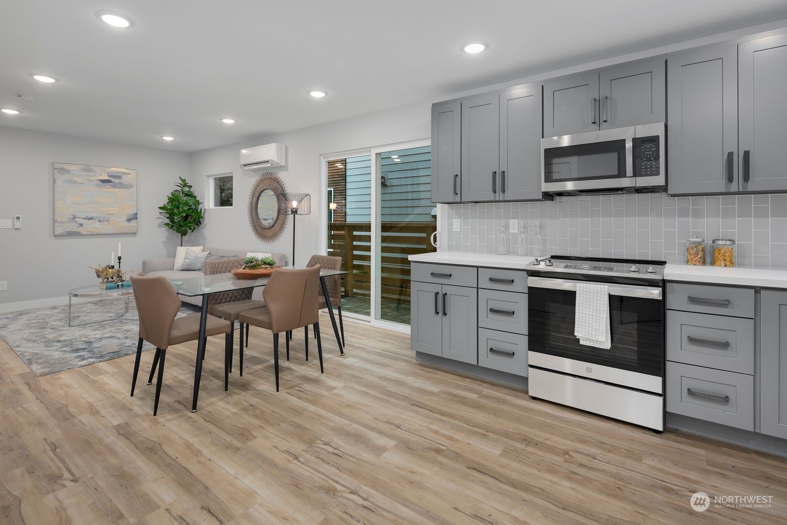 1006 B South Donovan Street Seattle, WA 98108 - Photo 10 of 14 a kitchen with stainless steel appliances a stove a sink cabinets and a wooden floor