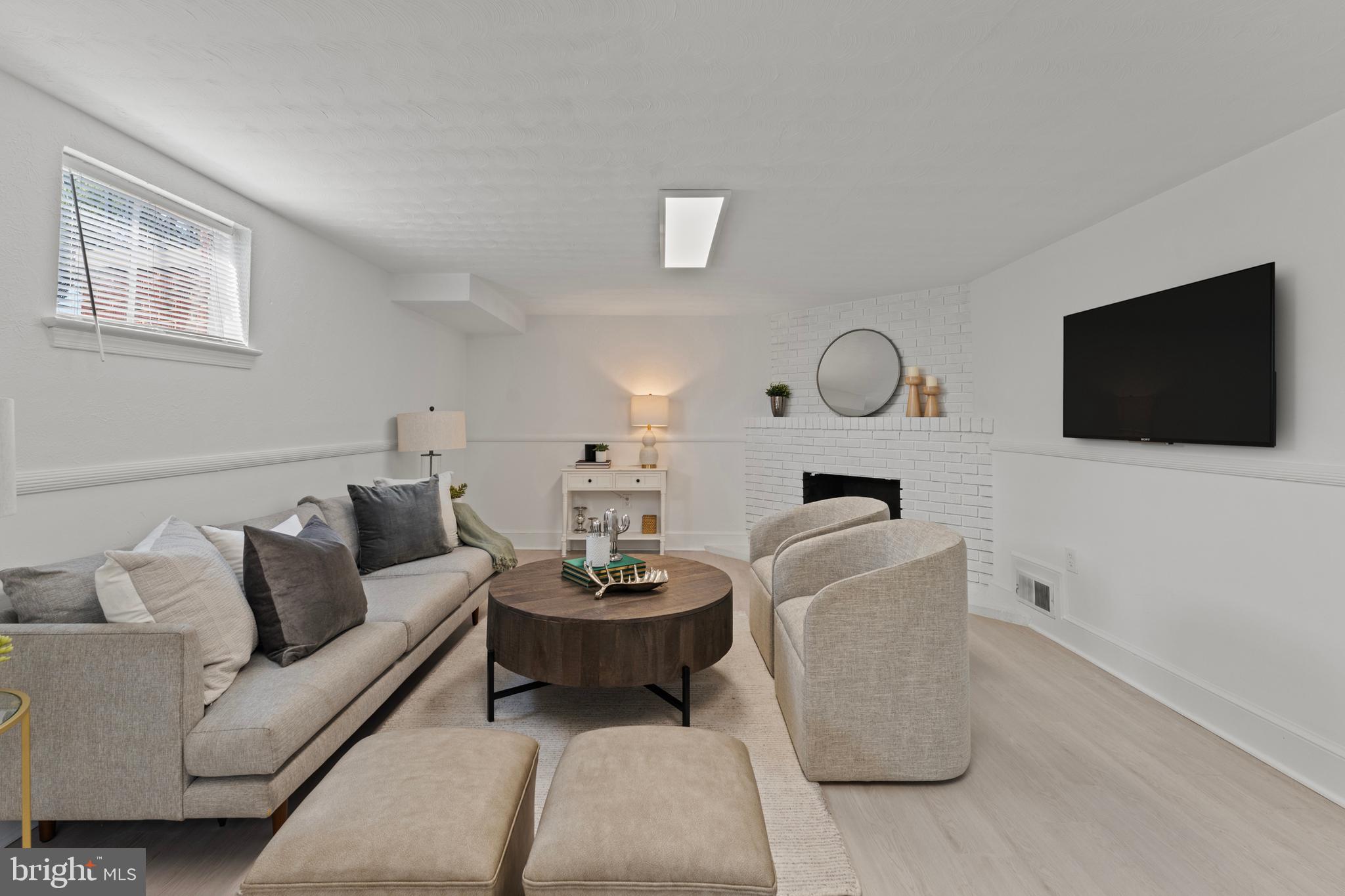 11006 Childs Street Silver Spring, MD 20901 - Photo 30 of 71 a living room with furniture and a flat screen tv
