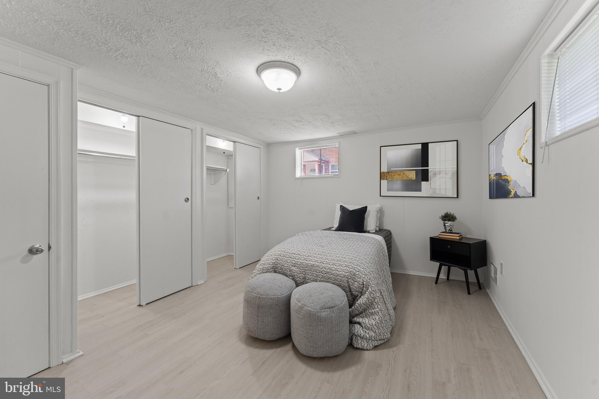 11006 Childs Street Silver Spring, MD 20901 - Photo 43 of 71 a spacious bedroom with a bed and a chair