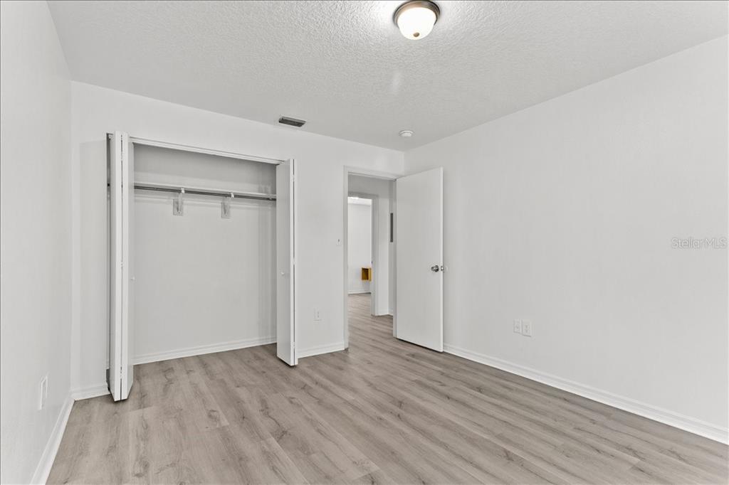 3417 Temple Street, Unit A Tampa, FL 33619 - Photo 14 of 30 a view of an empty room with wooden floor