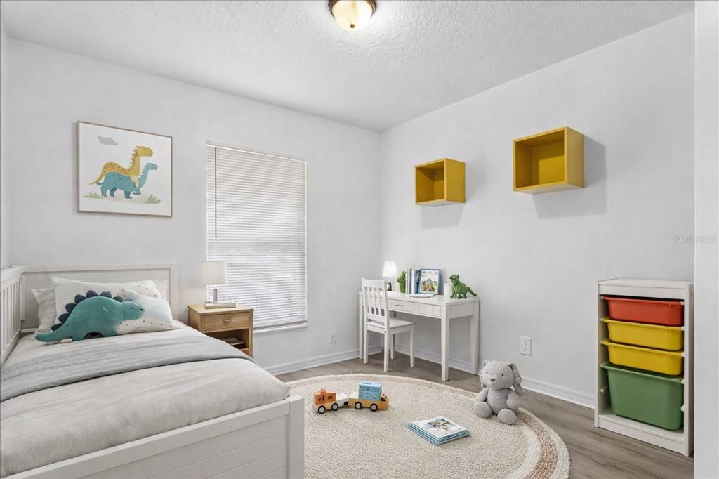 3417 Temple Street, Unit A Tampa, FL 33619 - Photo 19 of 30 a bedroom with a bed and a desk