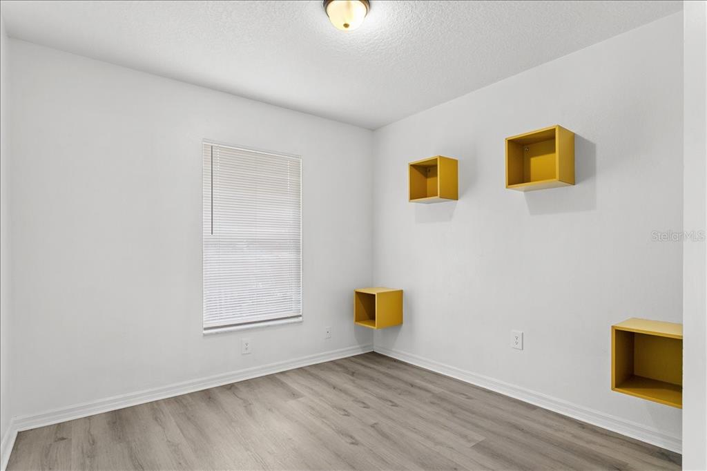 3417 Temple Street, Unit A Tampa, FL 33619 - Photo 20 of 30 a view of a room with wooden floor and window