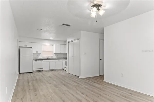 a kitchen with a refrigerator and a stove top oven