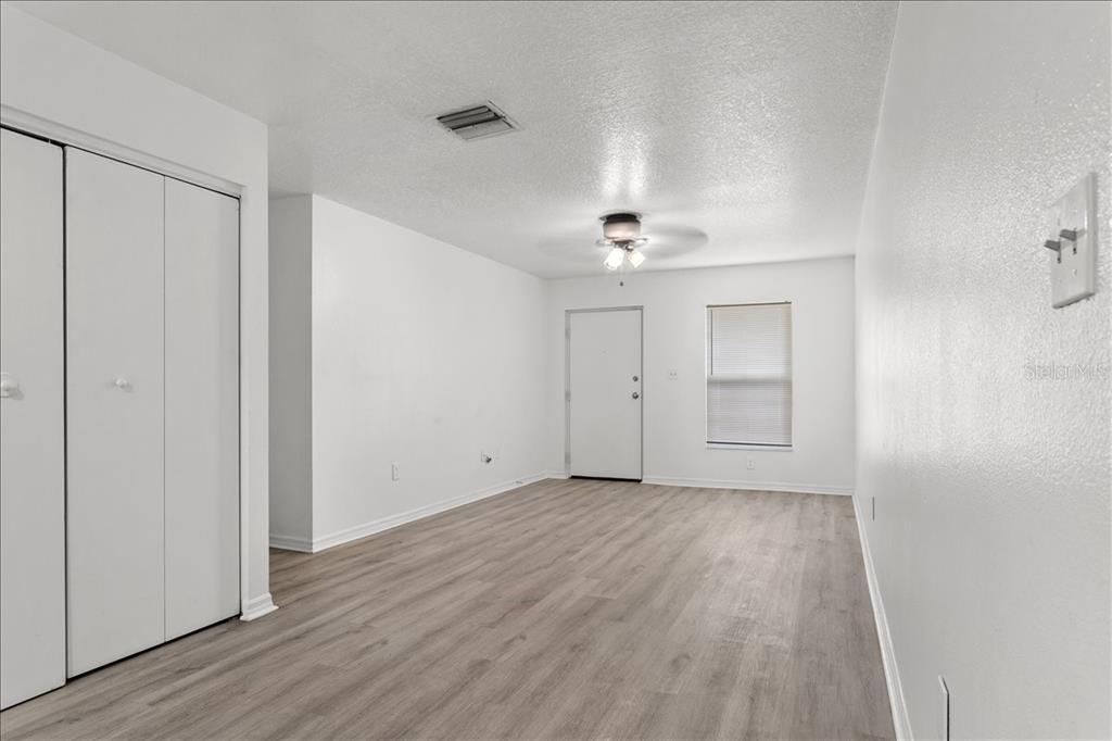 3417 Temple Street, Unit A Tampa, FL 33619 - Photo 5 of 30 a view of an empty room with wooden floor