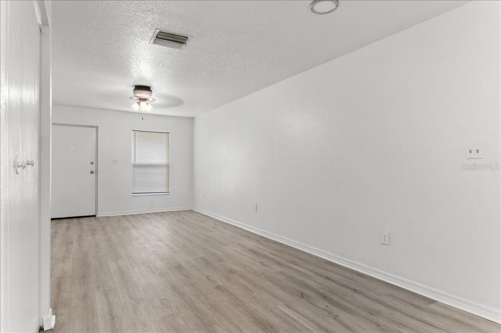 3417 Temple Street, Unit A Tampa, FL 33619 - Photo 8 of 30 a view of an empty room with wooden floor