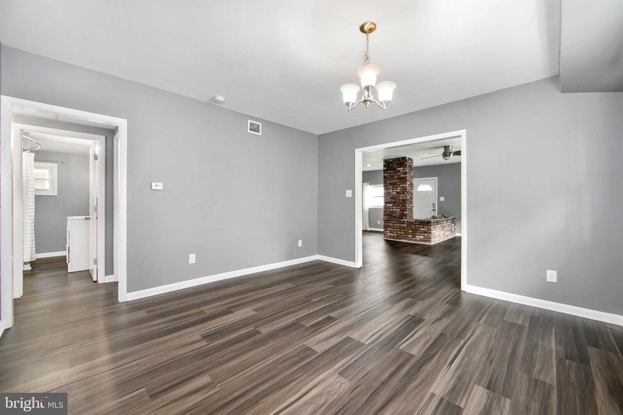 325 Landis Avenue Oaklyn, NJ 08107 - Photo 11 of 46 wooden floor in an empty room with a window
