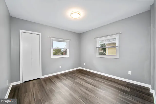 a view of room with window and wooden floor