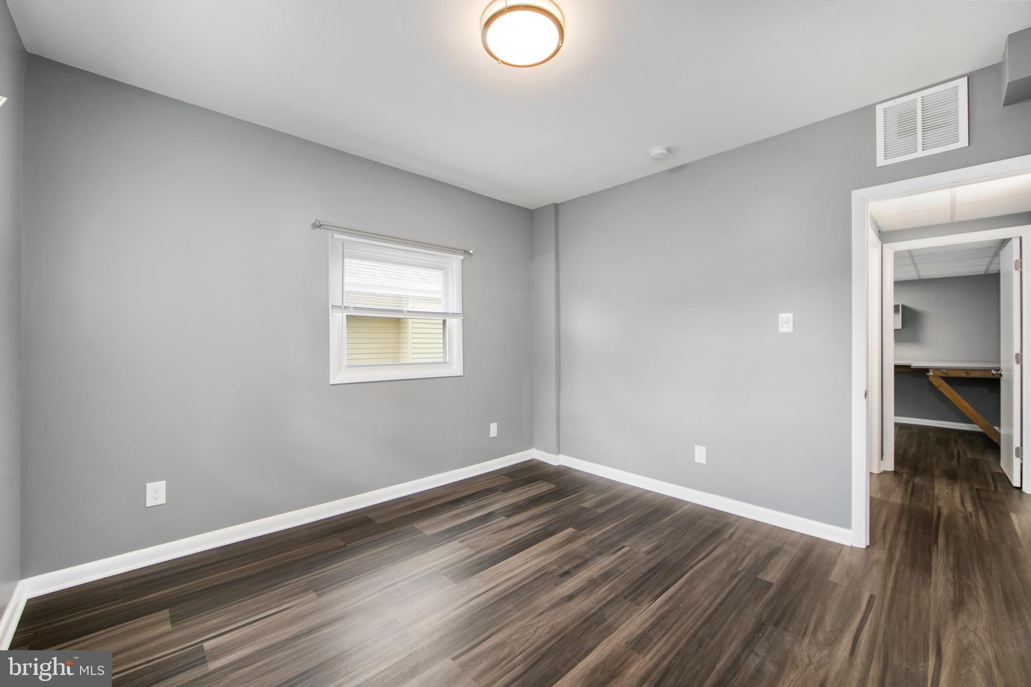325 Landis Avenue Oaklyn, NJ 08107 - Photo 16 of 46 wooden floor in an empty room with a window