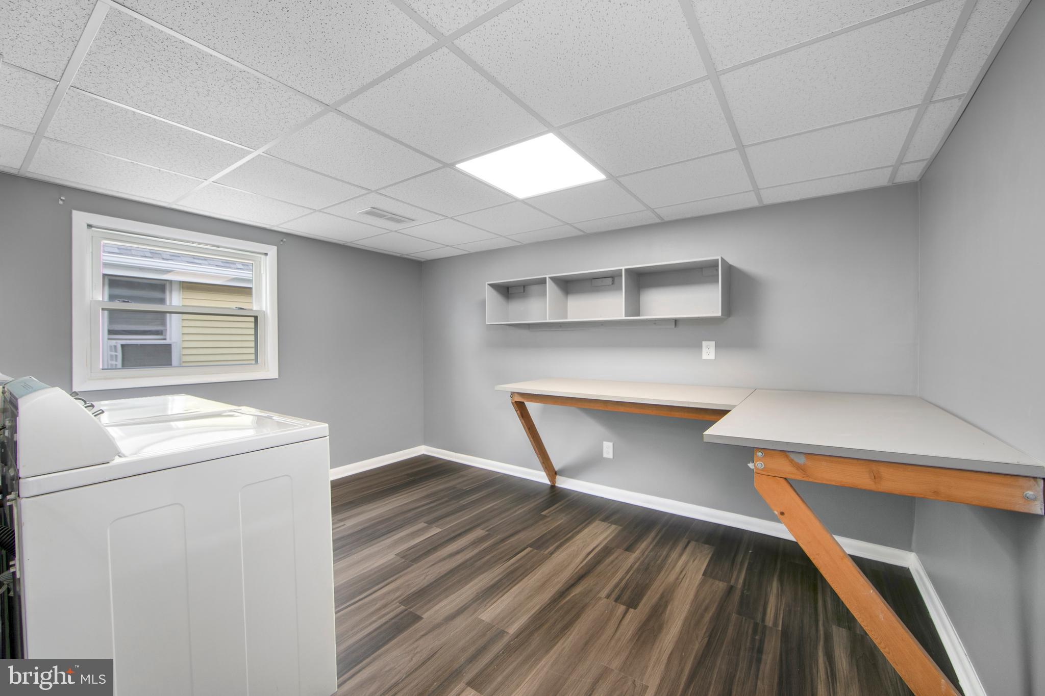 325 Landis Avenue Oaklyn, NJ 08107 - Photo 18 of 46 a view of washer and dryer with wooden cabinets