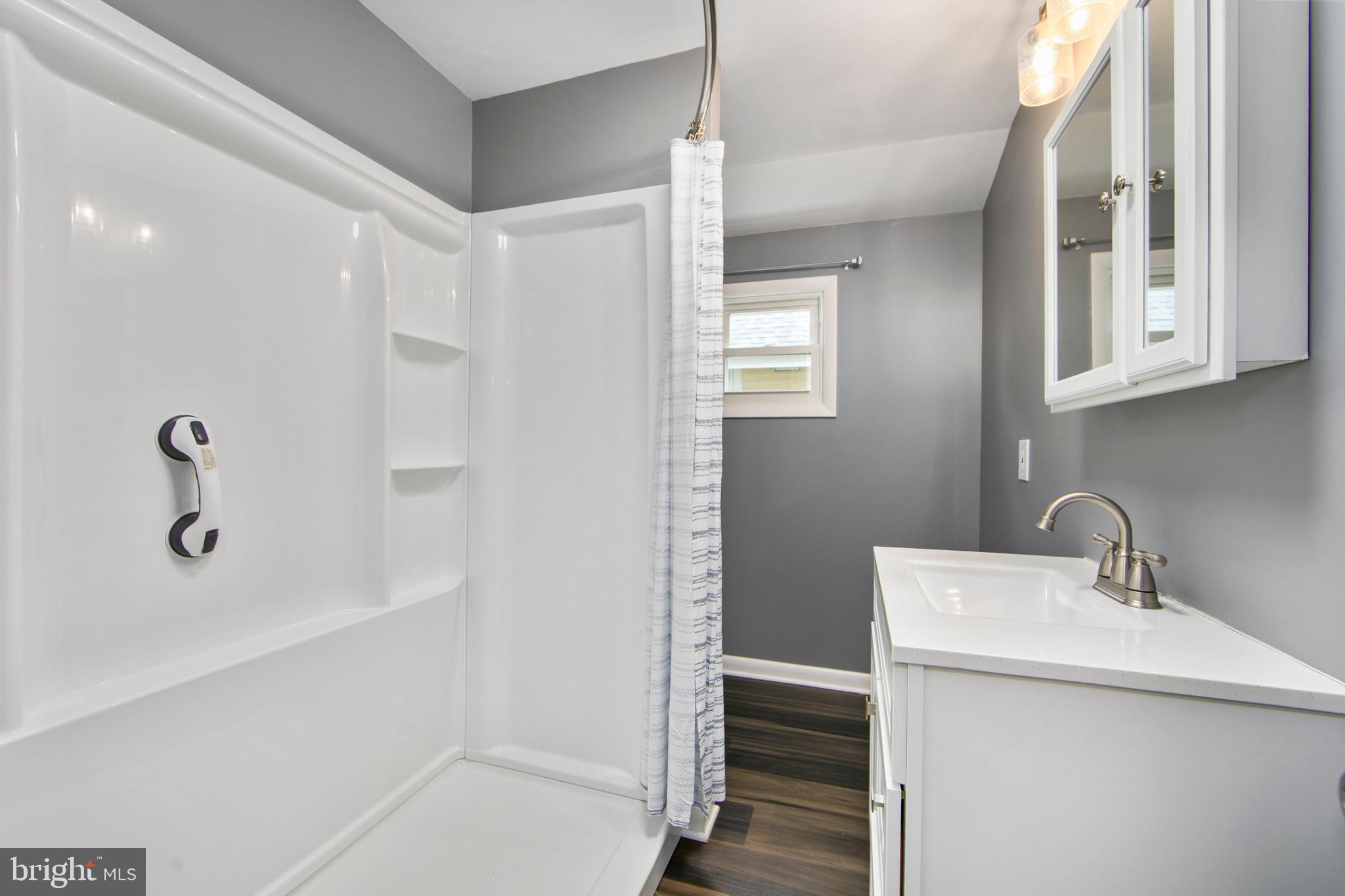 325 Landis Avenue Oaklyn, NJ 08107 - Photo 21 of 46 a bathroom with a sink a toilet and shower