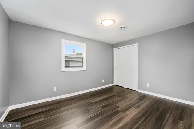 a view of wooden floor and windows in a room