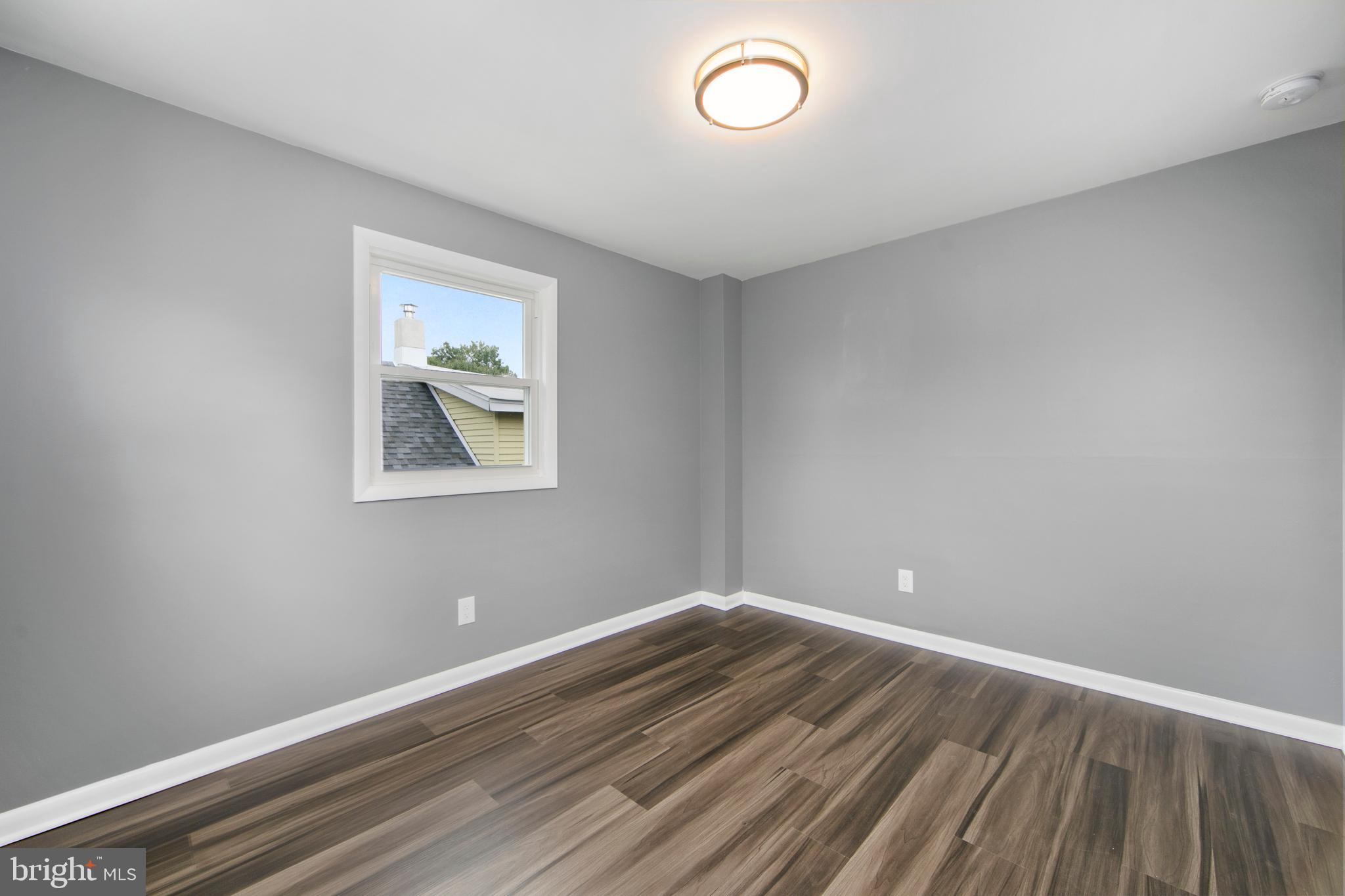 325 Landis Avenue Oaklyn, NJ 08107 - Photo 29 of 46 a view of room with wooden floor and window