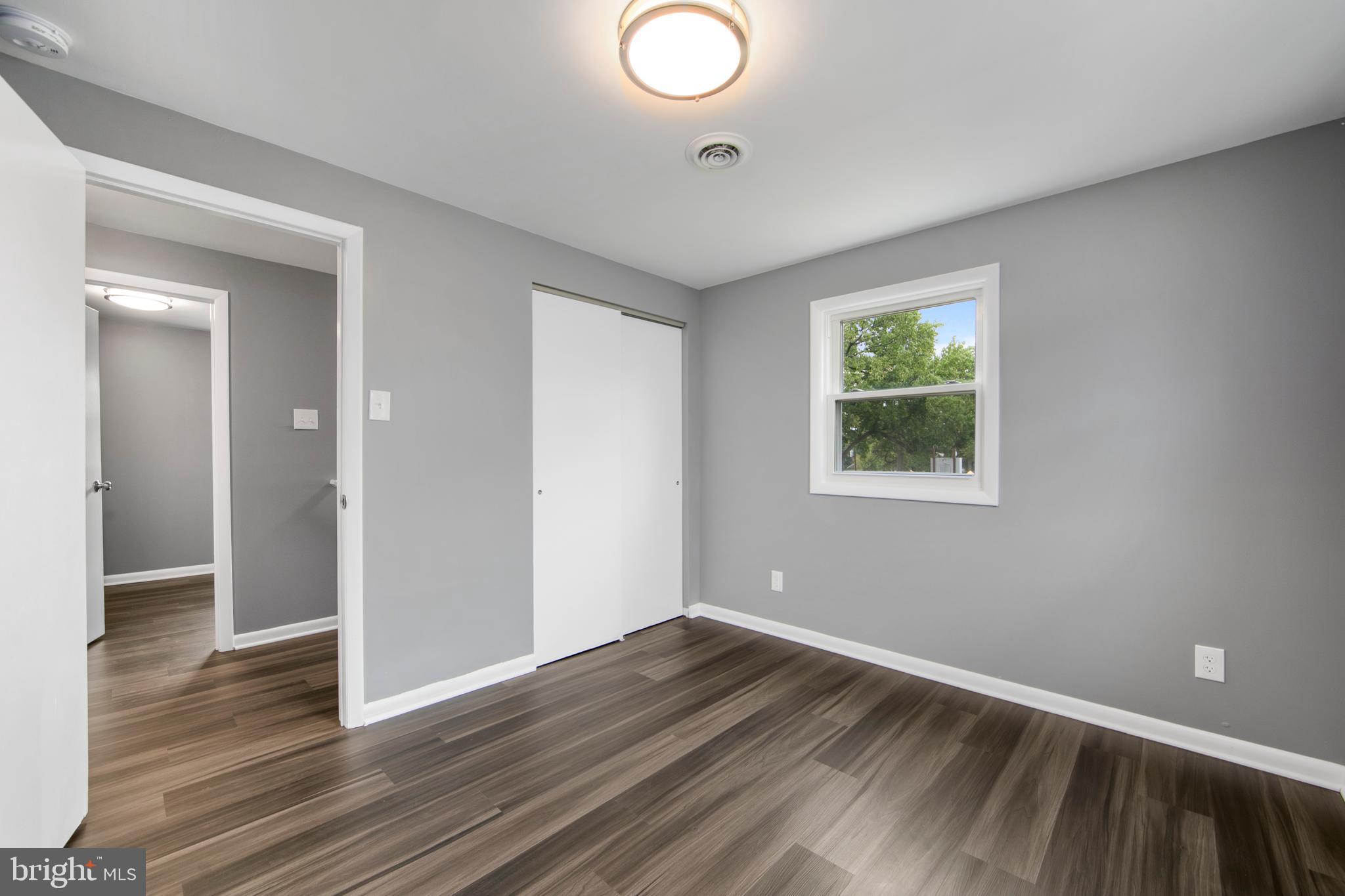 325 Landis Avenue Oaklyn, NJ 08107 - Photo 30 of 46 an empty room with wooden floor and windows