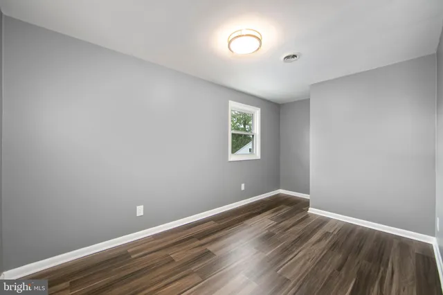 a view of room with window and hardwood floor