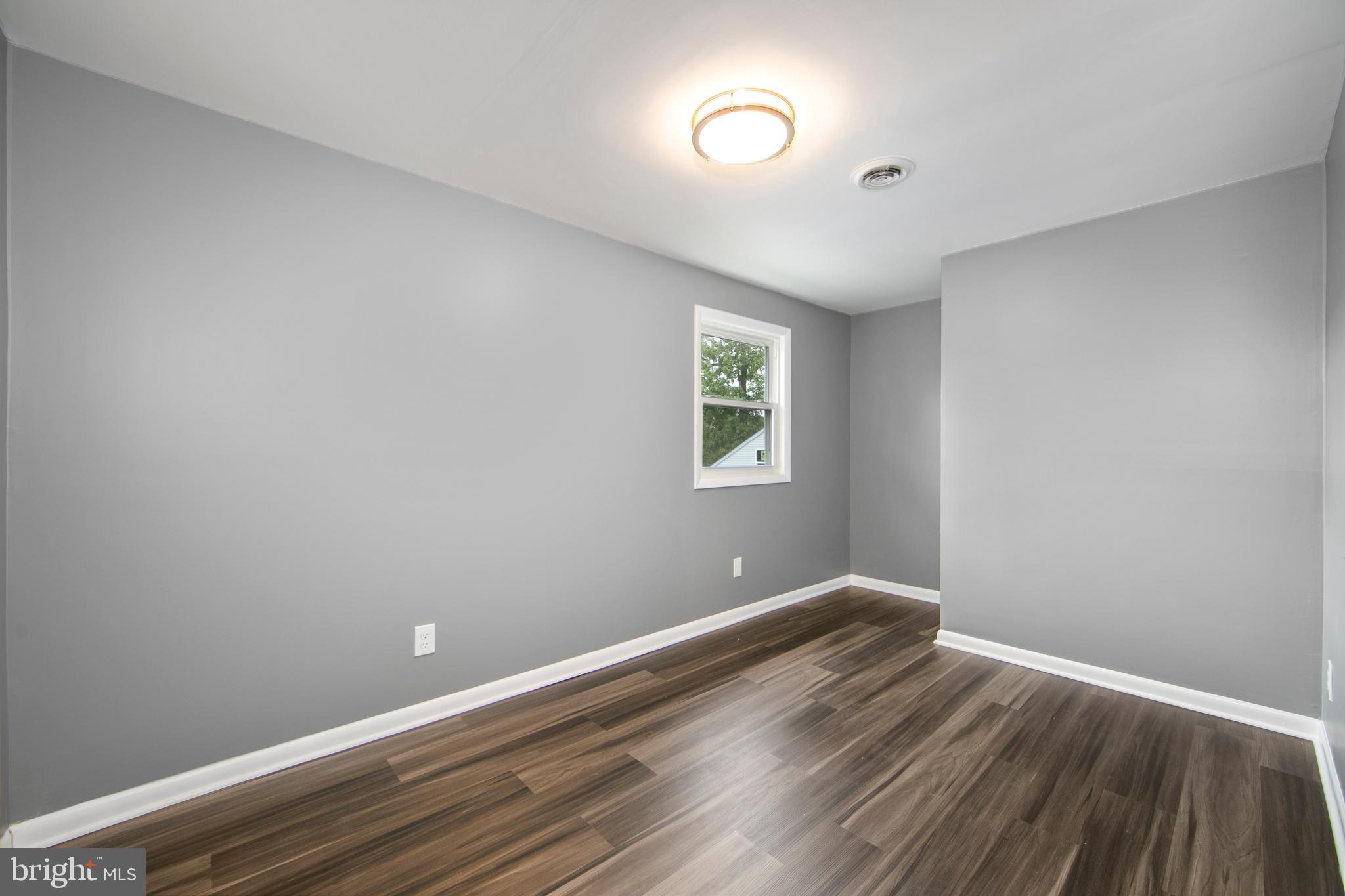 325 Landis Avenue Oaklyn, NJ 08107 - Photo 31 of 46 a view of room with window and hardwood floor