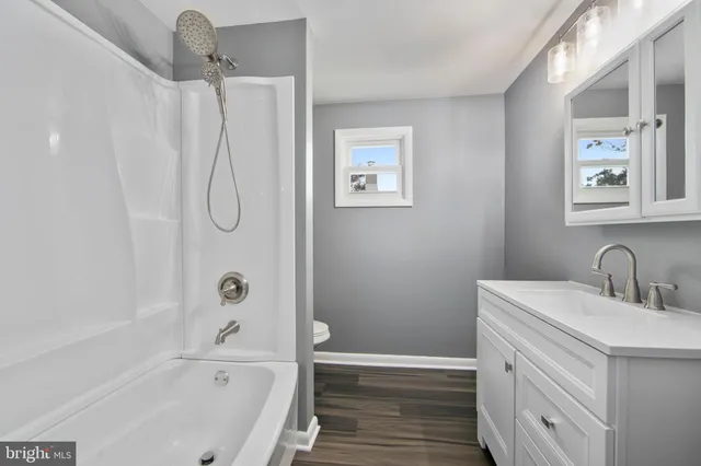 a bathroom with a bathtub a sink a vanity and a shower