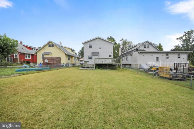 a view of a house with a big yard and large trees