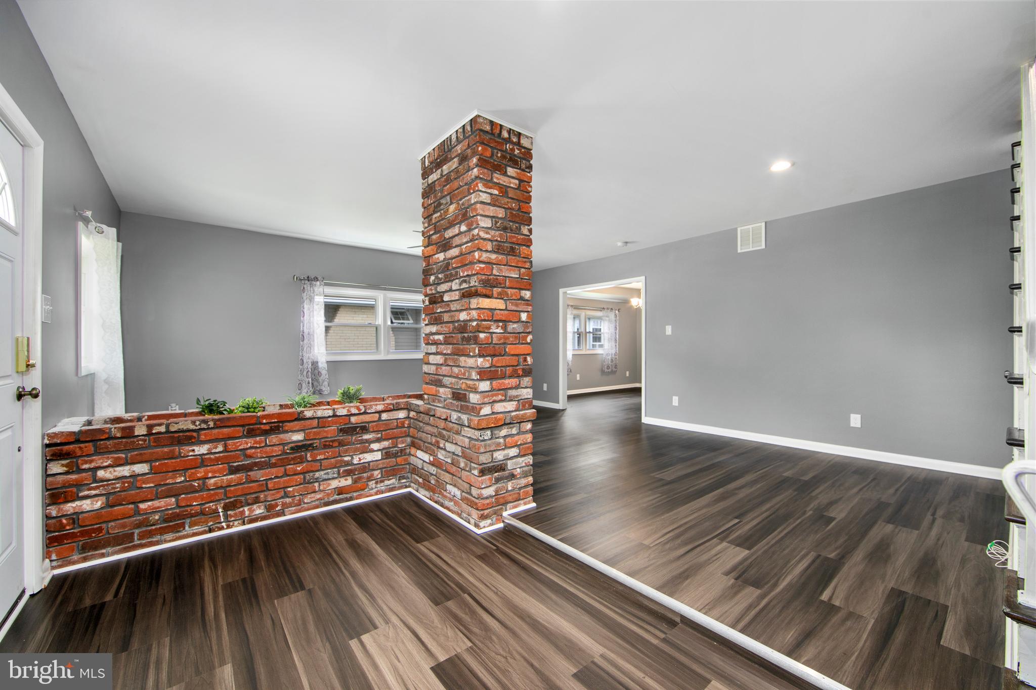 325 Landis Avenue Oaklyn, NJ 08107 - Photo 5 of 46 a view of an empty room with wooden floor and a window