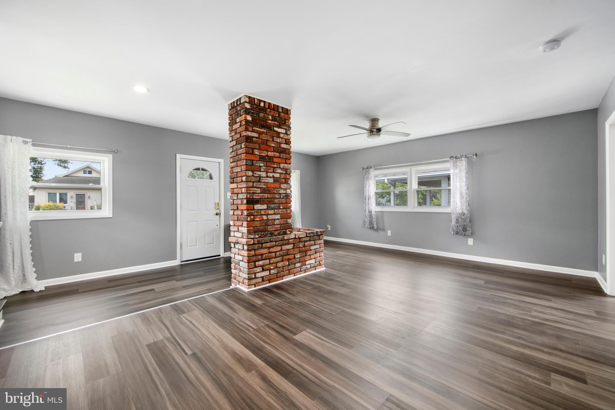 325 Landis Avenue Oaklyn, NJ 08107 - Photo 7 of 46 an empty room with wooden floor and windows