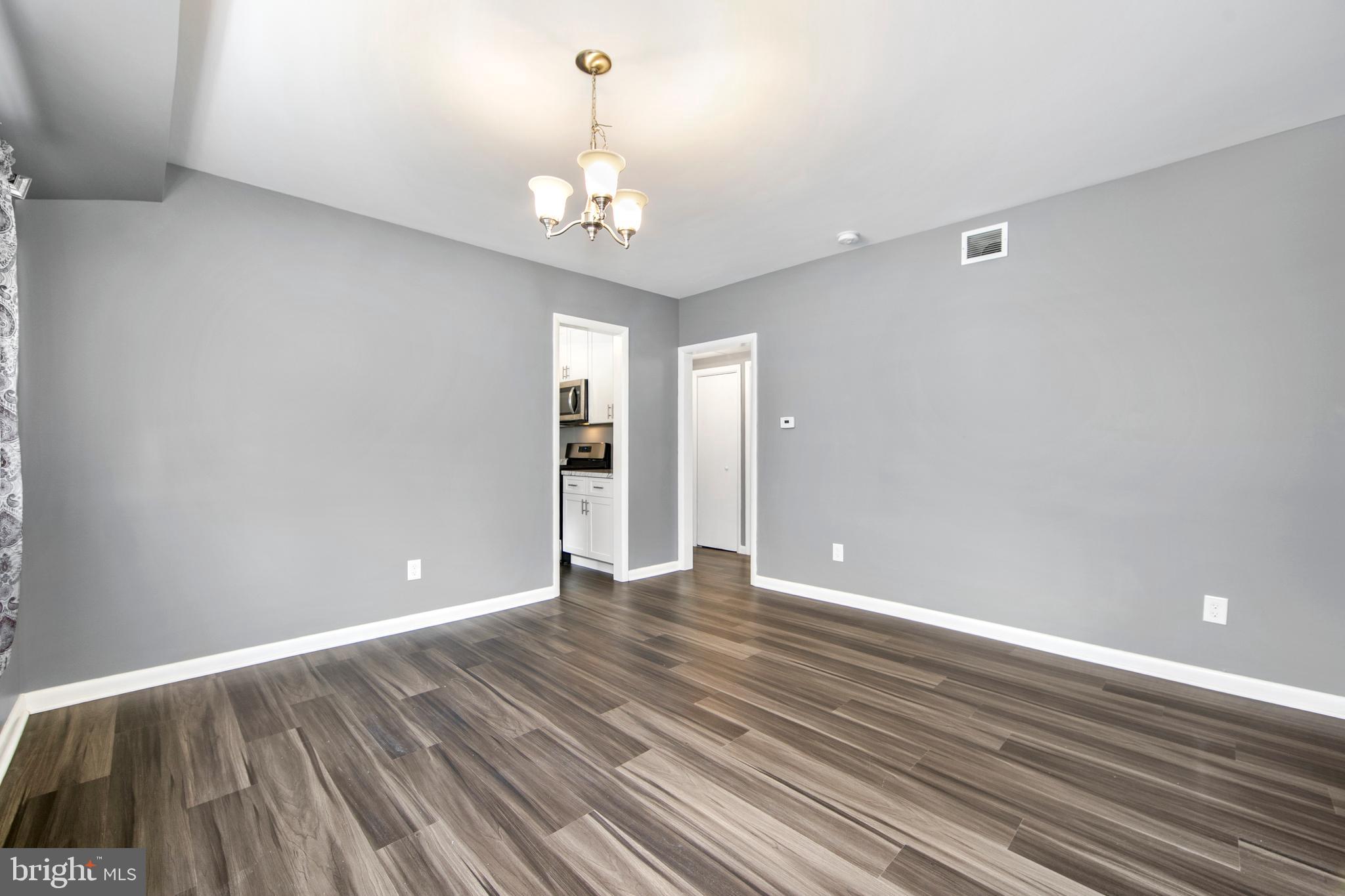 325 Landis Avenue Oaklyn, NJ 08107 - Photo 9 of 46 a view of an empty room with wooden floor and a window