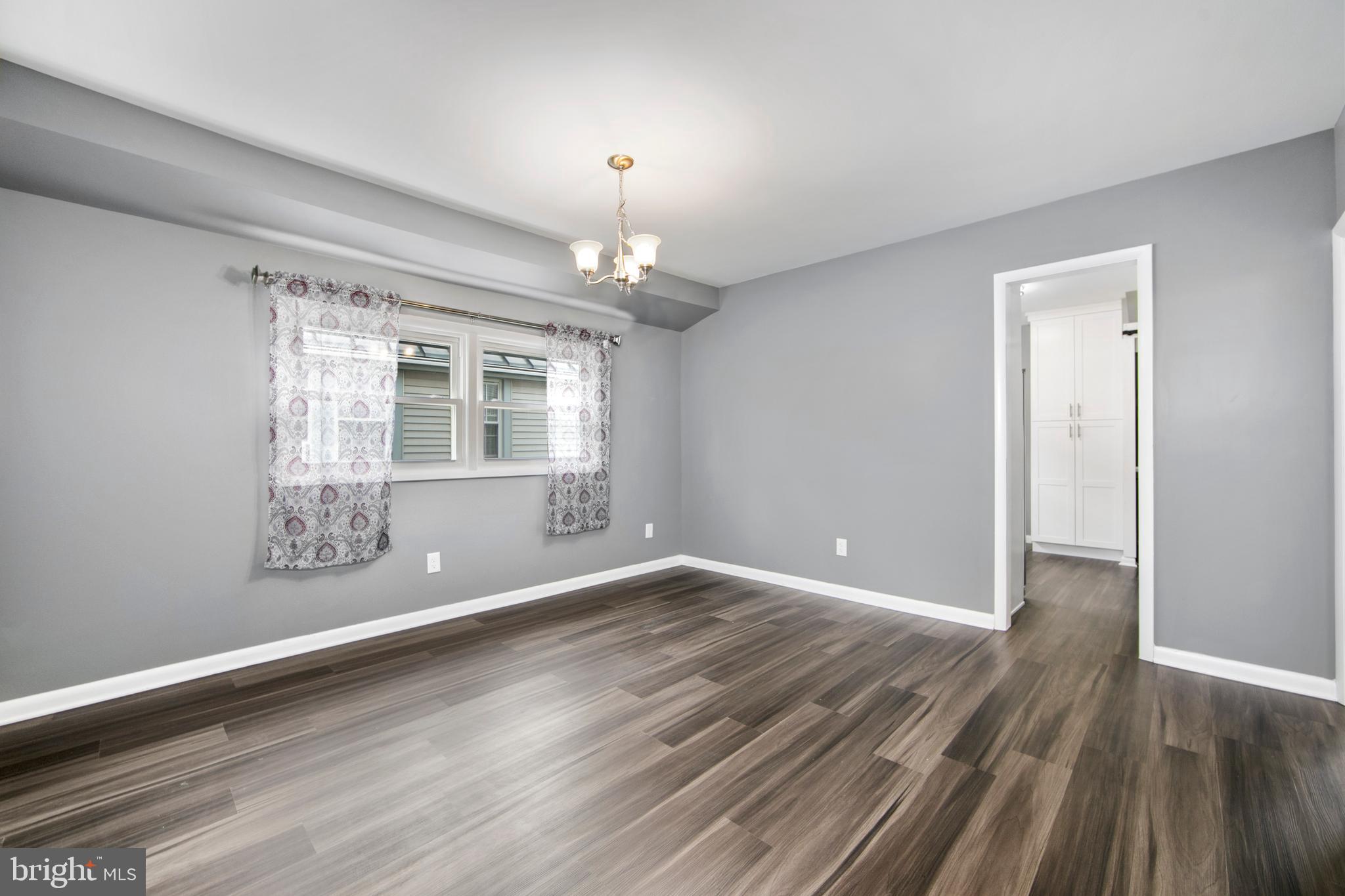325 Landis Avenue Oaklyn, NJ 08107 - Photo 10 of 46 a view of an empty room with wooden floor and a window