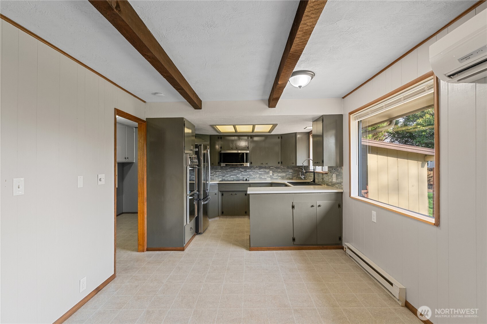 214 Talbot Street North Montesano, WA 98563 - Photo 8 of 40 a room with stainless steel appliances kitchen island granite countertop a refrigerator a oven a sink dishwasher and white cabinets with wooden floor