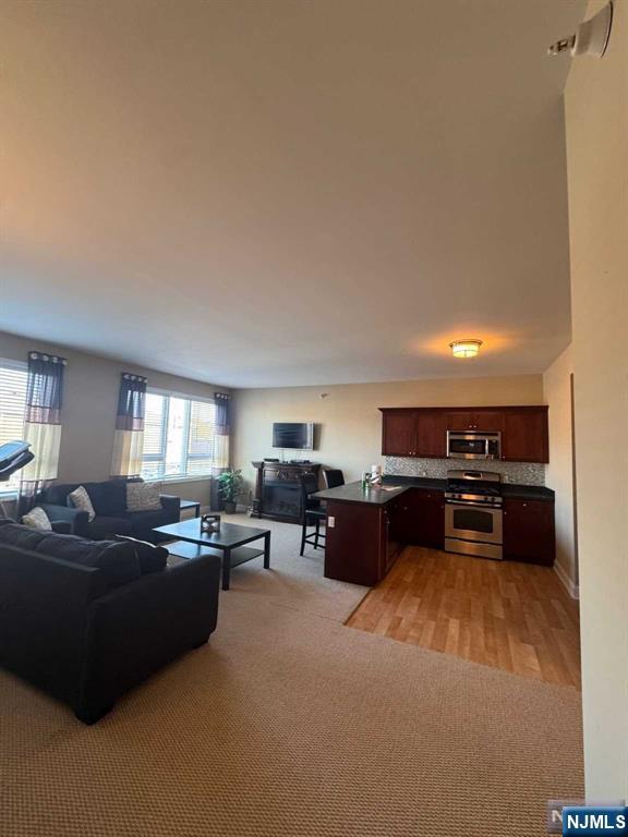 447 Fairview Avenue, Unit 304 Fairview, NJ 07022 - Photo 4 of 12 a living room with furniture and a couch
