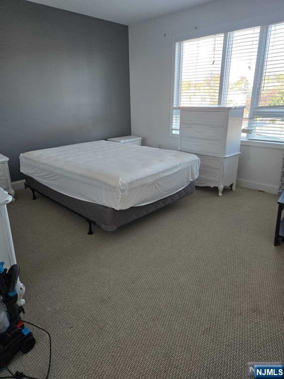 447 Fairview Avenue, Unit 304 Fairview, NJ 07022 - Photo 8 of 12 a bedroom with a bed and a window
