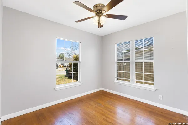 an empty room with wooden floor and closet