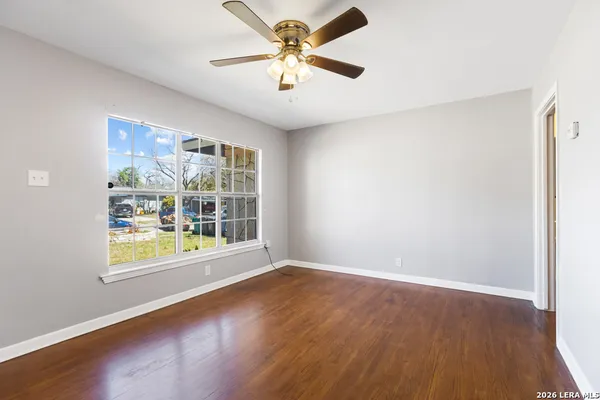 wooden floor in an empty room with a window