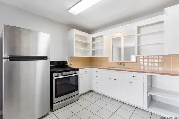 a kitchen with a sink stove and cabinets