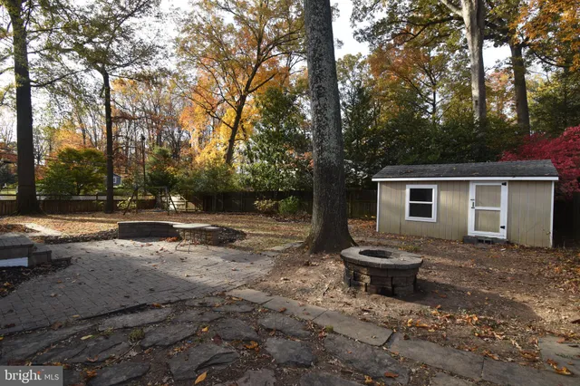 a view of a backyard with table and chairs and a fire pit