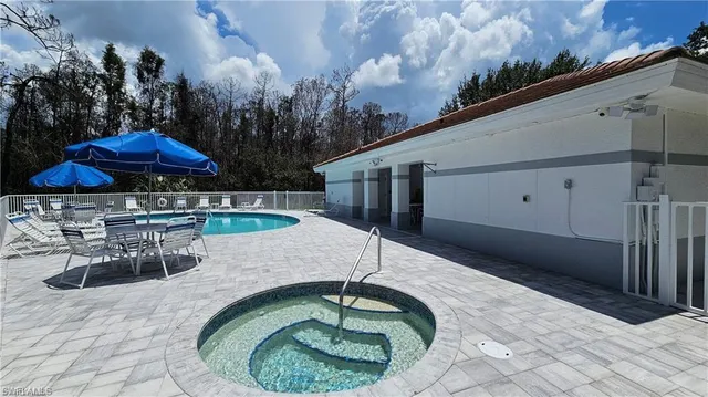 a swimming pool with outdoor seating yard and outdoor seating