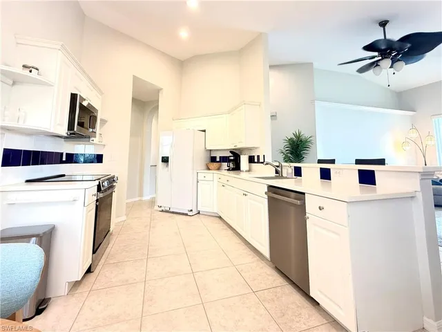 a kitchen with cabinets and white appliances