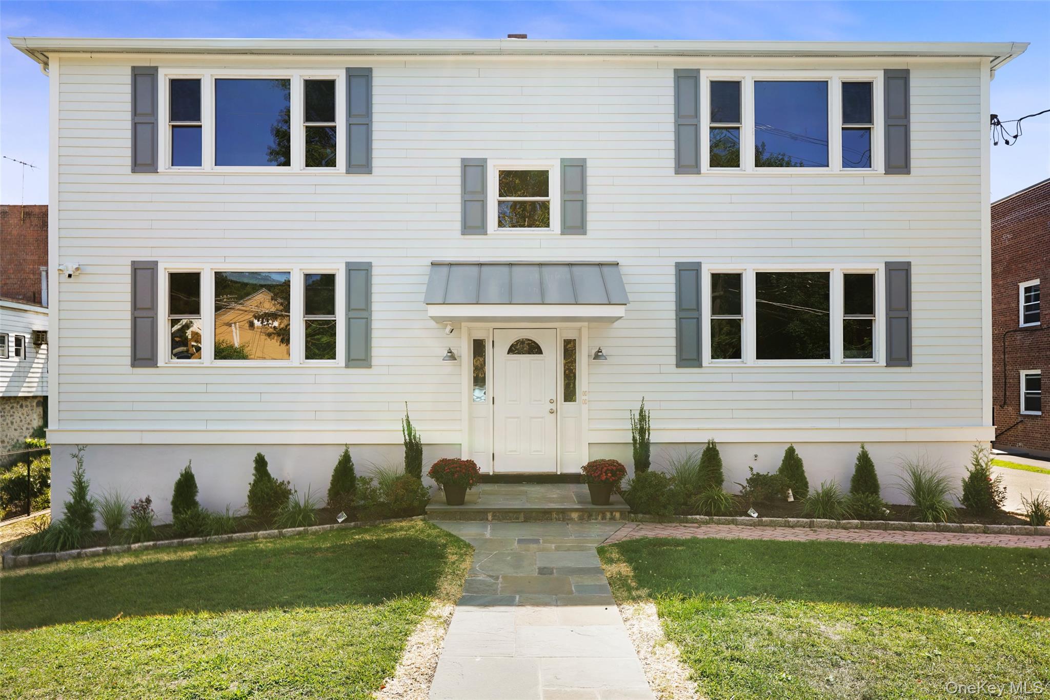 11 Orchard Avenue, Unit 3 Rye, NY 10580 - Photo 10 of 11 a front view of a house with a yard