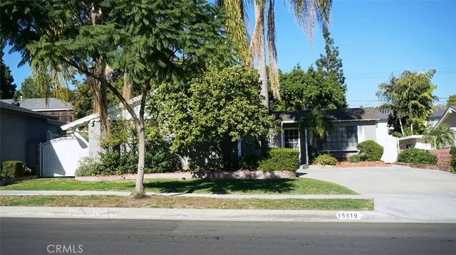 a view of a house with a yard and tree s