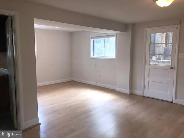 an empty room with windows and closet