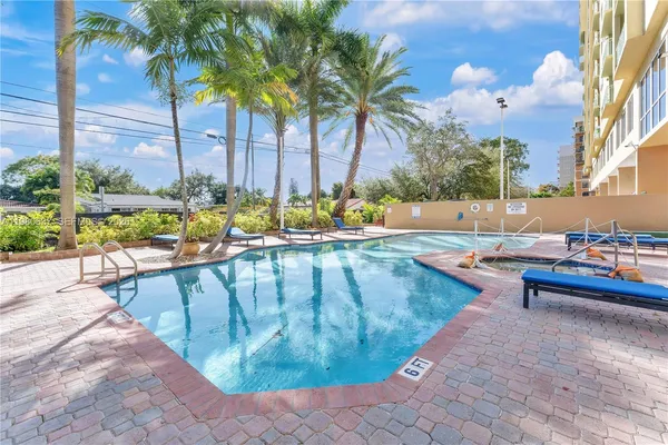 a view of swimming pool with outdoor seating and plants