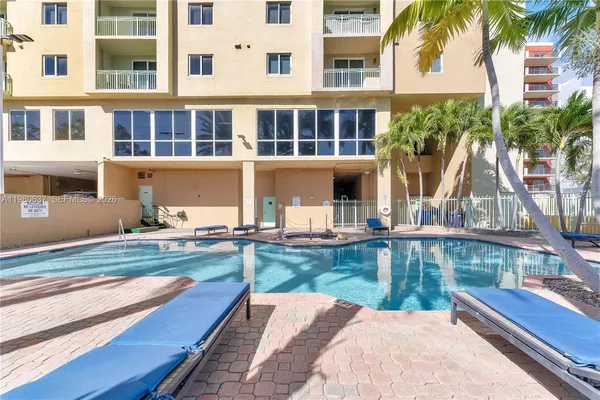 a view of a house with pool and sitting area