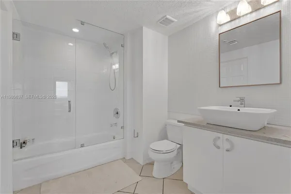 a bathroom with a sink toilet a shower and bathtub