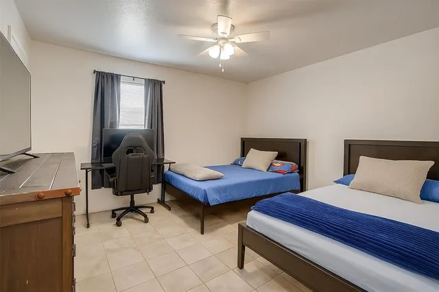 a bedroom with two beds and a chandelier