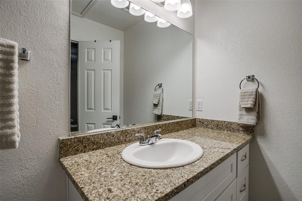 408 South Cleburne Whitney Road Rio Vista, TX 76093 - Photo 13 of 16 a bathroom with a granite countertop sink and a mirror