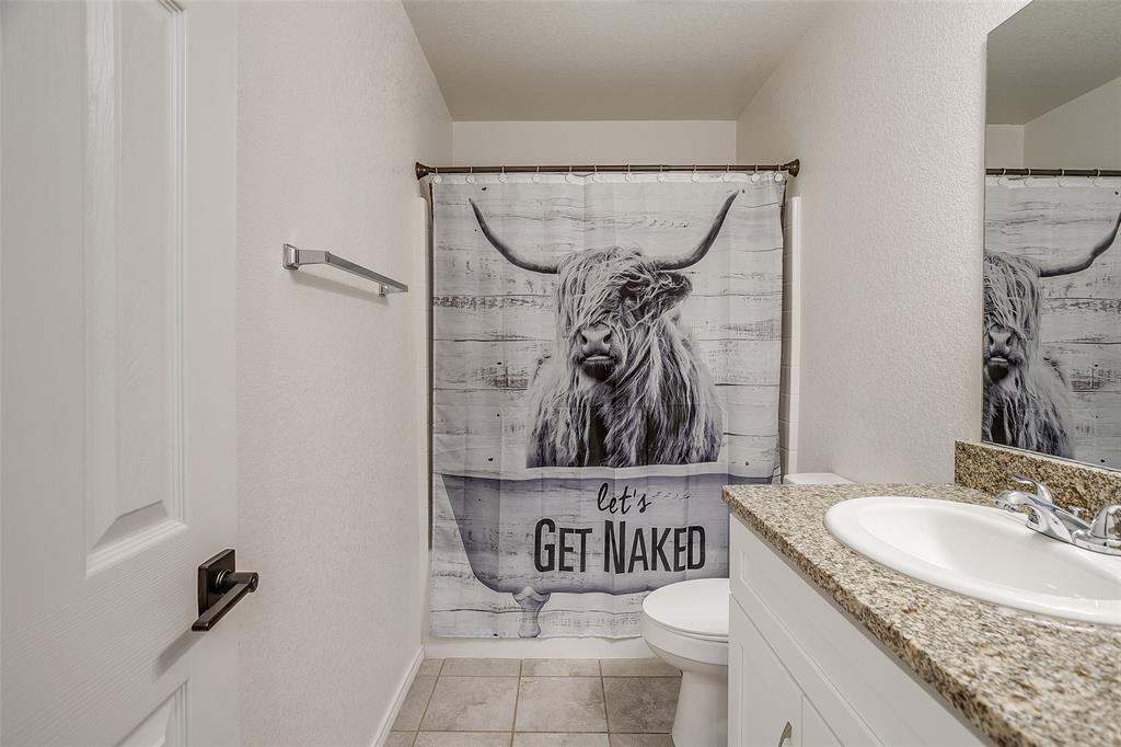 408 South Cleburne Whitney Road Rio Vista, TX 76093 - Photo 15 of 16 a bathroom with a granite countertop sink a toilet and a mirror