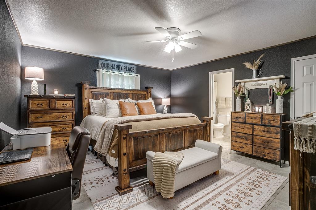 408 South Cleburne Whitney Road Rio Vista, TX 76093 - Photo 10 of 16 a bedroom with a bed and wooden floor