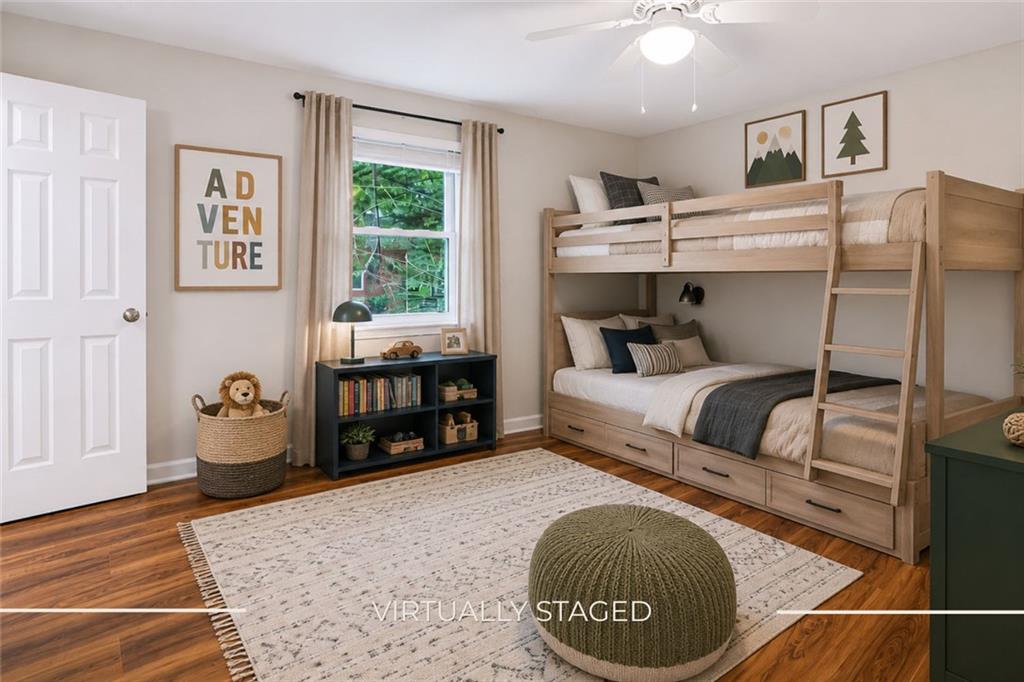 3193 East Point Street, Unit 4 Atlanta, GA 30344 - Photo 12 of 20 a bedroom with a bed and wooden floor