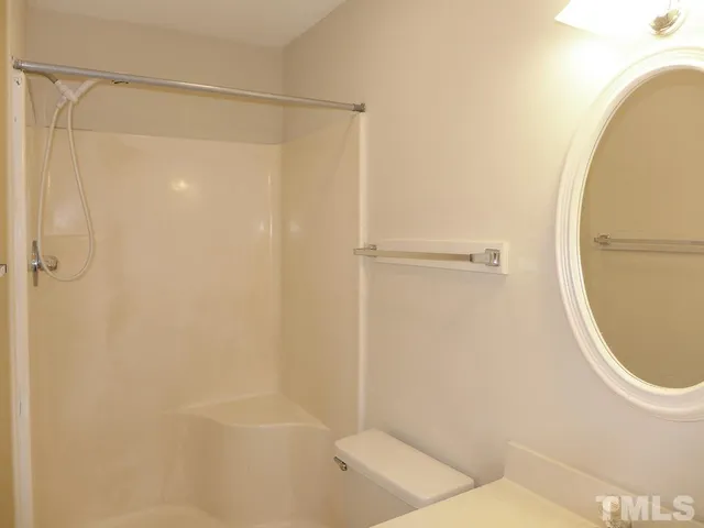 a bathroom with a shower and a toilet