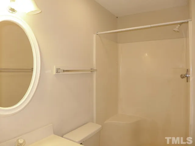 a bathroom with a shower and a mirror